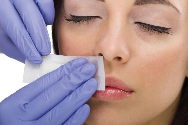 Waxing on woman's face